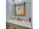 Bathroom with granite countertops and a rustic framed mirror at 540 Benton Rd, Covington, GA 30014