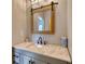 Bathroom with granite countertops and a rustic framed mirror at 540 Benton Rd, Covington, GA 30014