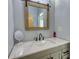 Bathroom with granite countertops and a rustic framed mirror at 540 Benton Rd, Covington, GA 30014