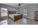 Bright bedroom with a rustic wooden bed frame and luxury vinyl plank flooring at 540 Benton Rd, Covington, GA 30014