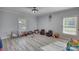 Spacious bonus room with gray wood floors, neutral walls, and lots of natural light at 540 Benton Rd, Covington, GA 30014