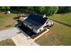 Exterior aerial of newly constructed home with a black metal roof, white siding, and professional landscaping at 540 Benton Rd, Covington, GA 30014