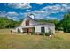 Stylish barn house featuring a black roof, manicured garden, and a lush green lawn at 540 Benton Rd, Covington, GA 30014
