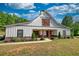Attractive farmhouse with covered porch and detailed landscaping at 540 Benton Rd, Covington, GA 30014