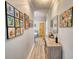 Hallway featuring gray wood floors and a gallery wall of Gathering photos at 540 Benton Rd, Covington, GA 30014