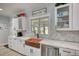 Charming kitchen features a copper sink, white cabinets, and natural light from the window at 540 Benton Rd, Covington, GA 30014