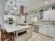 Updated kitchen with large island, seating, stainless appliances, designer fixtures, and wood floors at 540 Benton Rd, Covington, GA 30014