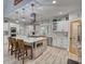 Modern kitchen with a large island, stainless steel appliances, custom cabinets, and wood floors at 540 Benton Rd, Covington, GA 30014