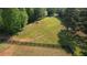 Large section of land surrounded by lush green trees and a fence, offering endless possibilities for building or recreation at 540 Benton Rd, Covington, GA 30014