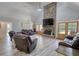 Cozy living room featuring a stone fireplace, wood floors, and comfortable leather seating arrangement at 540 Benton Rd, Covington, GA 30014