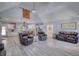 Open-concept living space with wood floors and a barn door feature with a view to the kitchen at 540 Benton Rd, Covington, GA 30014