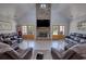 Open living room with high ceilings, stone fireplace, wood floors, and comfortable leather seating at 540 Benton Rd, Covington, GA 30014