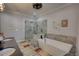 Bathroom featuring a glass shower, soaking tub, and lots of natural light at 540 Benton Rd, Covington, GA 30014