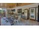 Covered outdoor kitchen area with stainless steel appliances, a dining table, and a ceiling fan at 540 Benton Rd, Covington, GA 30014