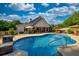 Backyard pool with outdoor dining area, wooded surroundings, and a sunny sky at 540 Benton Rd, Covington, GA 30014