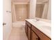 Bathroom features a double sink vanity, tiled flooring, and a shower-tub combo at 9872 Cameron Parc Cir, Johns Creek, GA 30022