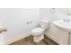 Clean, half bathroom with pedestal sink, and white fixtures at 9872 Cameron Parc Cir, Johns Creek, GA 30022