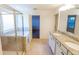 Bathroom featuring double vanity sinks, a glass enclosed shower, and a soaking tub at 9872 Cameron Parc Cir, Johns Creek, GA 30022