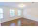 Bedroom with hardwood flooring, natural light from windows, and neutral-colored walls, creating a serene atmosphere at 9872 Cameron Parc Cir, Johns Creek, GA 30022