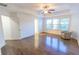 Large bedroom with hardwood floors, a trey ceiling, and a comfortable armchair at 9872 Cameron Parc Cir, Johns Creek, GA 30022