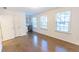 Bedroom features hardwood floors, closet, windows with blinds, and built-in desk area at 9872 Cameron Parc Cir, Johns Creek, GA 30022