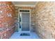Close-up of a stylish front door with brick and stone accents plus a welcome mat at 9872 Cameron Parc Cir, Johns Creek, GA 30022