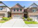 Beautiful brick townhome featuring a two-car garage and well-manicured landscaping at 9872 Cameron Parc Cir, Johns Creek, GA 30022