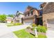 Brick townhome with a two-car garage and neatly landscaped front yard in a suburban neighborhood at 9872 Cameron Parc Cir, Johns Creek, GA 30022