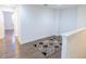 Upstairs hallway features hardwood floors and a neutral-colored rug, offering a clean and modern aesthetic at 9872 Cameron Parc Cir, Johns Creek, GA 30022