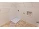 Bright laundry room with durable tile flooring and wire shelving for storage at 9872 Cameron Parc Cir, Johns Creek, GA 30022