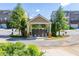 Community mail kiosk featuring a covered structure with stone pillars and manicured landscaping at 9872 Cameron Parc Cir, Johns Creek, GA 30022