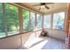 Bright sunroom featuring large windows, wood-look flooring, neutral paint, and a ceiling fan, creating a relaxing space at 9872 Cameron Parc Cir, Johns Creek, GA 30022