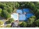 An aerial view of the community pool and tennis courts, surrounded by lush greenery at 1105 Anemone Nw Way, Acworth, GA 30102