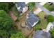 Drone view of a house with a patio, beautiful landscaping, and mature trees at 1105 Anemone Nw Way, Acworth, GA 30102