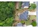Overhead shot of a landscaped property with well-maintained lawn, mature trees, and a patio at 1105 Anemone Nw Way, Acworth, GA 30102