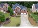 Stunning aerial view of a brick home with a well-manicured lawn and a spacious two-car garage at 1105 Anemone Nw Way, Acworth, GA 30102