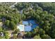 Community amenities include a pool and tennis courts near a lake and lush trees at 1105 Anemone Nw Way, Acworth, GA 30102