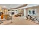 Finished basement with carpet, a door to the exterior, a TV, an elliptical and weight equipment at 1105 Anemone Nw Way, Acworth, GA 30102
