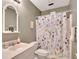 Bathroom with single sink vanity, a floral shower curtain, and neutral wall color at 1105 Anemone Nw Way, Acworth, GA 30102