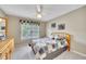 Cozy bedroom with a ceiling fan, closet, and a window providing natural light at 1105 Anemone Nw Way, Acworth, GA 30102