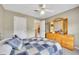 Bright bedroom with ceiling fan, closet, and natural light streaming through the window at 1105 Anemone Nw Way, Acworth, GA 30102