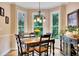 Charming breakfast nook with multiple windows offering views of greenery and a stylish light fixture at 1105 Anemone Nw Way, Acworth, GA 30102
