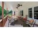 View of the covered back deck furnished with ceiling fans, rocking chairs, and lounge seating at 1105 Anemone Nw Way, Acworth, GA 30102