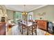 Elegant dining room with wooden table and chairs, complemented by a sideboard and a large window at 1105 Anemone Nw Way, Acworth, GA 30102