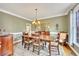 Traditional dining room with chandelier, wall sconces and an elegant area rug on hardwood flooring at 1105 Anemone Nw Way, Acworth, GA 30102
