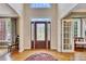 Inviting home foyer featuring a decorative front door, high ceilings, and beautiful hardwood floors at 1105 Anemone Nw Way, Acworth, GA 30102