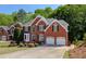 Charming brick home boasts well-maintained landscaping and an attached two-car garage at 1105 Anemone Nw Way, Acworth, GA 30102