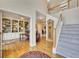 Spacious hallway featuring hardwood floors, a staircase, and an open doorway to the home office at 1105 Anemone Nw Way, Acworth, GA 30102