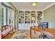 Comfortable home office featuring custom built-in shelving, a wooden desk, and a cozy bench at 1105 Anemone Nw Way, Acworth, GA 30102