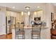 Updated kitchen features stainless steel appliances, granite countertops, and modern pendant lighting at 1105 Anemone Nw Way, Acworth, GA 30102
